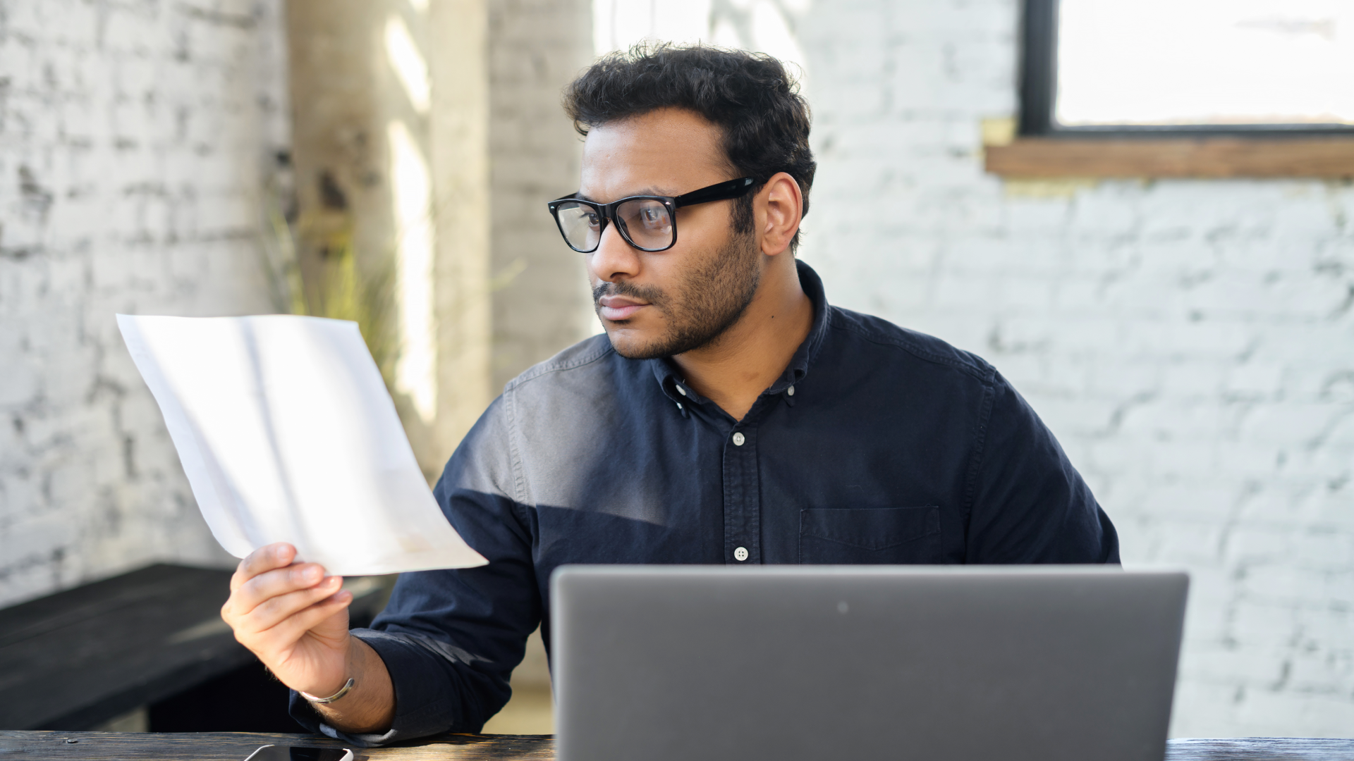 Professional reviewing a report to analyze drivers of trade promotion effectiveness.