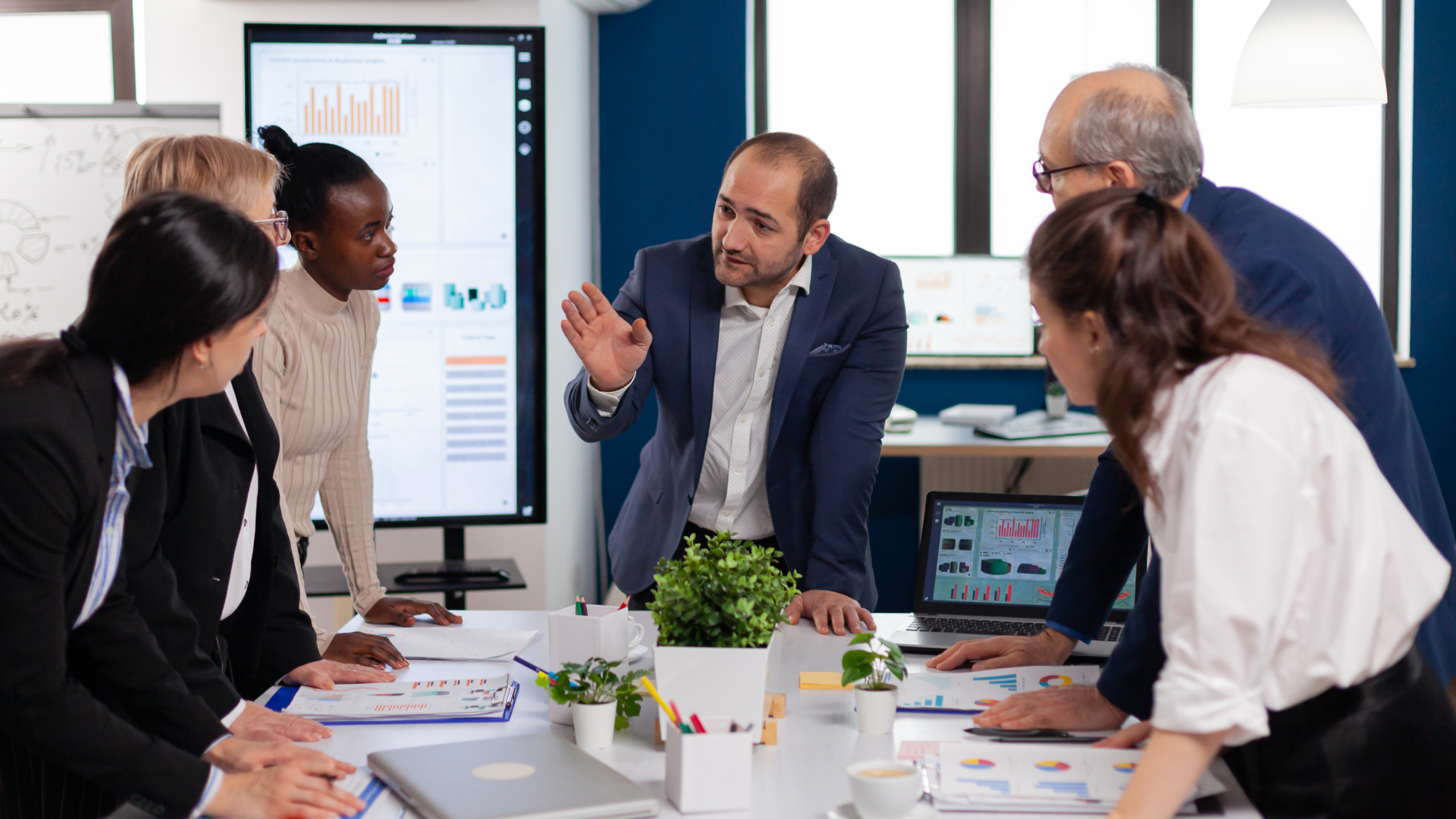 Team reviewing charts and reports while measuring trade promotion effectiveness.