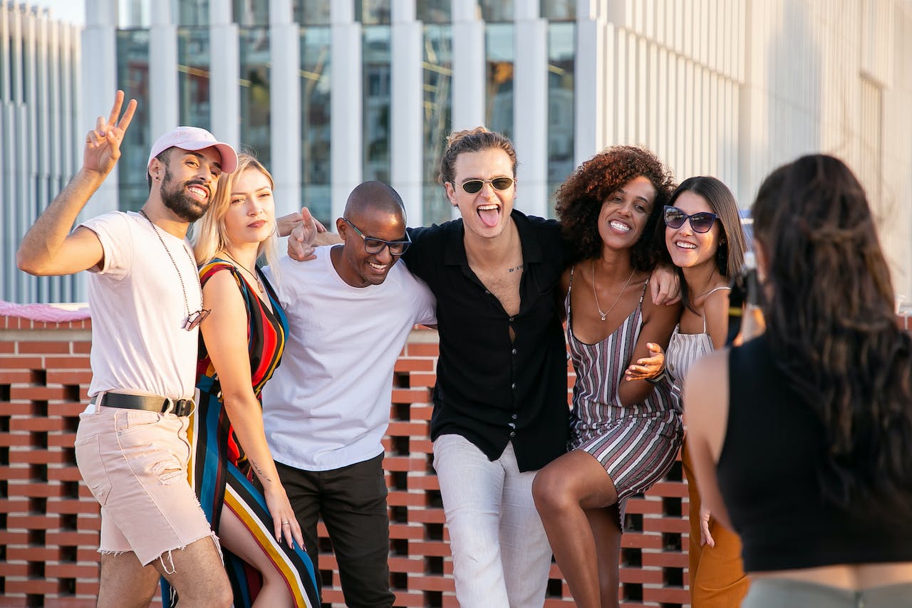 Friend group posing on a sunny rooftop