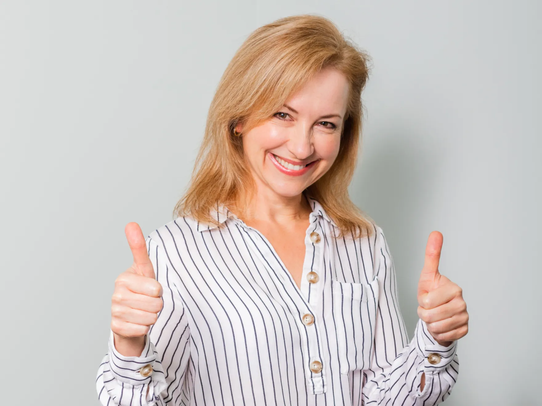 Team member with both thumbs up