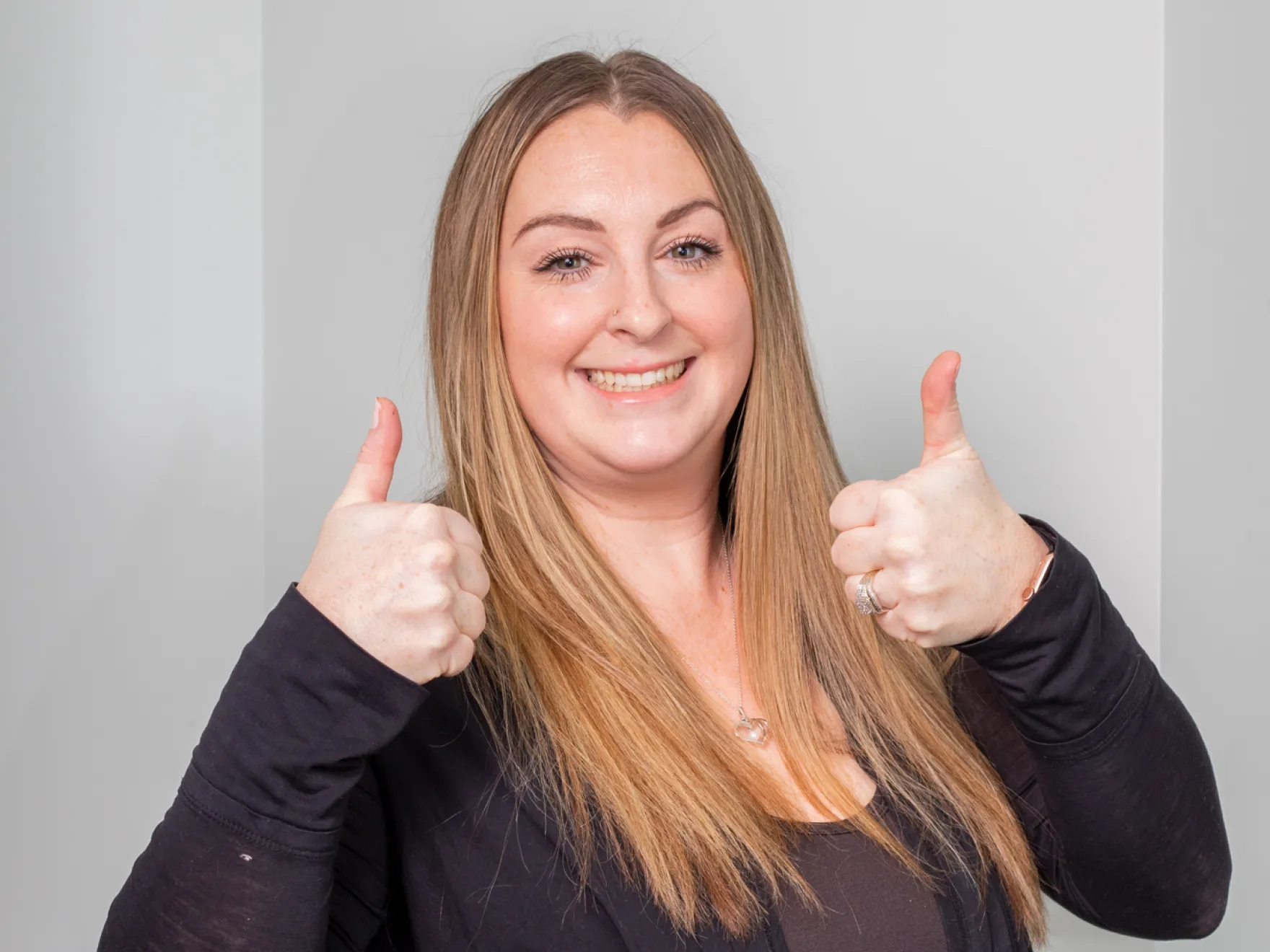 A woman giving the thumbs up sign.
