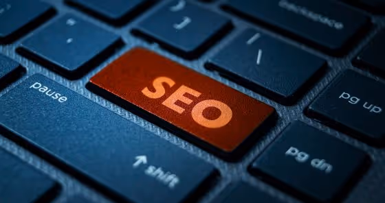 Close-up of a computer keyboard with an orange key labeled SEO.