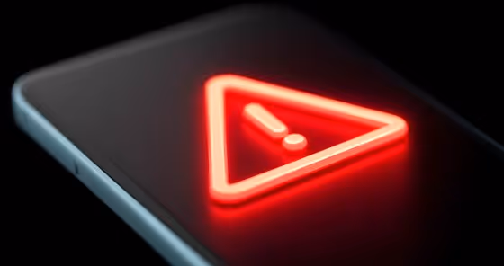 Smartphone screen displaying a red glowing warning triangle with an exclamation mark.