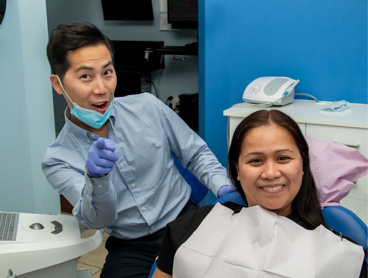 Happy dentist with patient