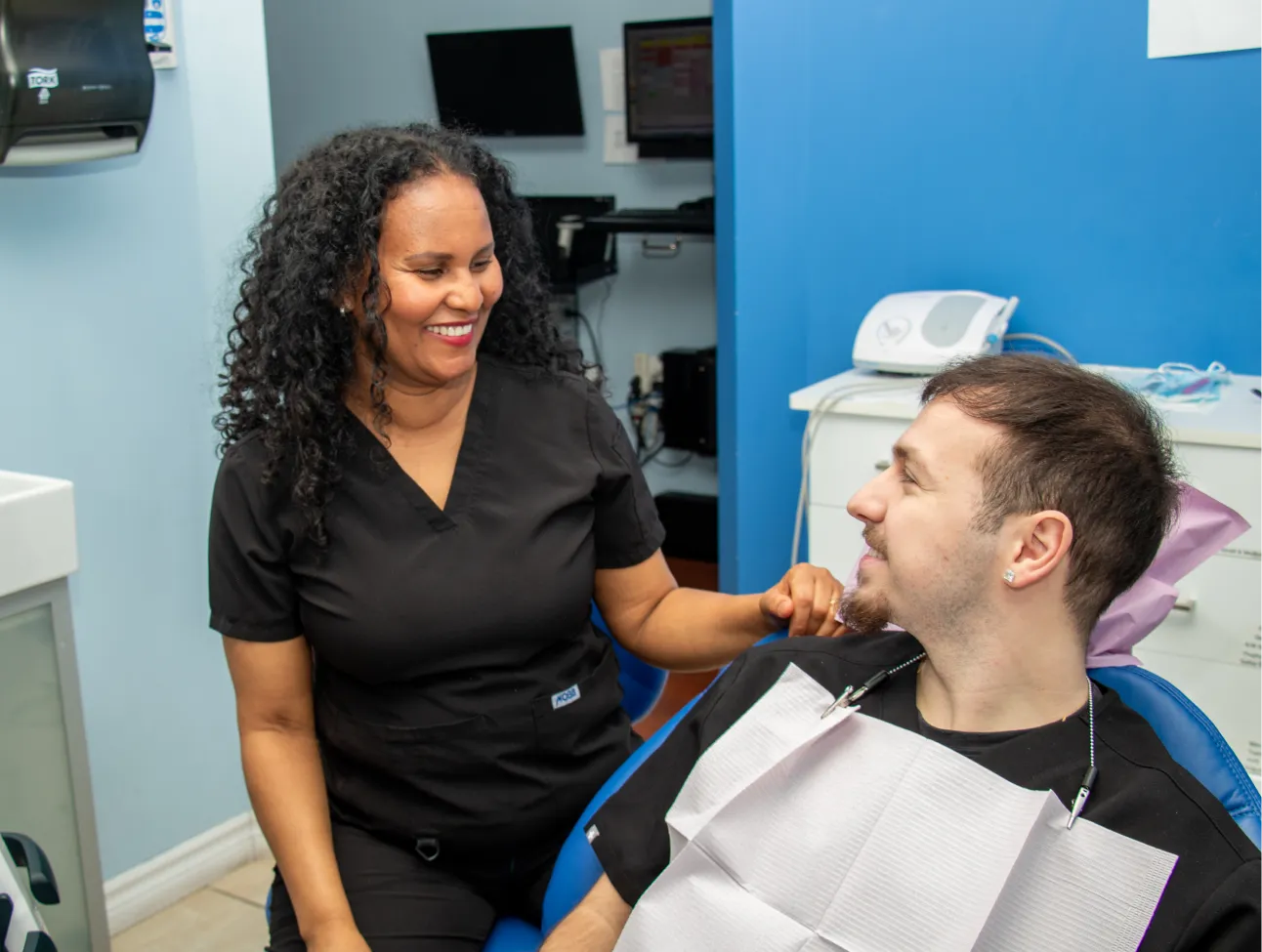 Six Points Plaza Dental team member smiling to patient