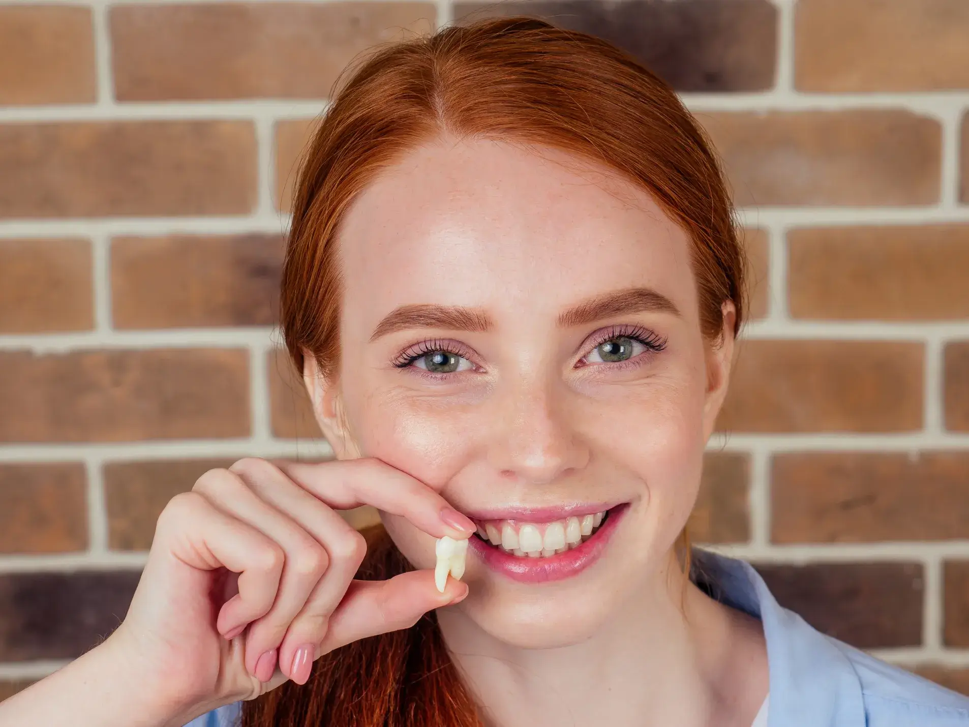 Woman holding a dental crown