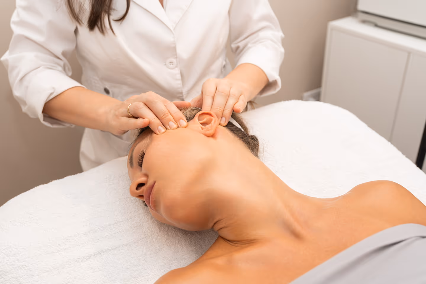 Professional facial and neck massage performed during a spa treatment