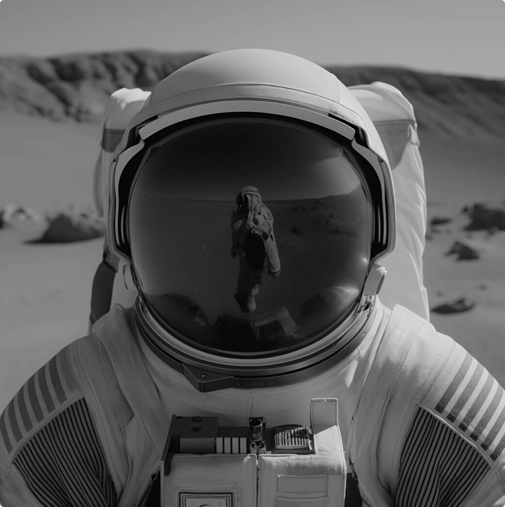 Man with his hands in front of his face wearing rings and an orange sweatshirt.
