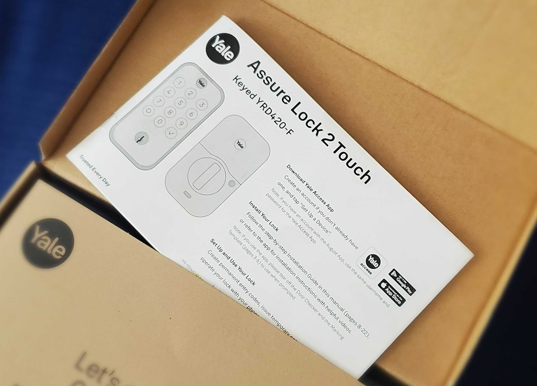 Yale Assure Lock 2 Touch keyed YRD420-F installation and setup guide inside a cardboard box.