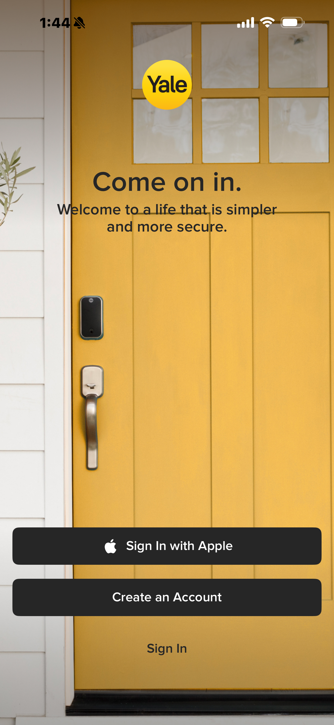 Yellow front door with smart lock and Yale logo inviting users to sign in or create an account.