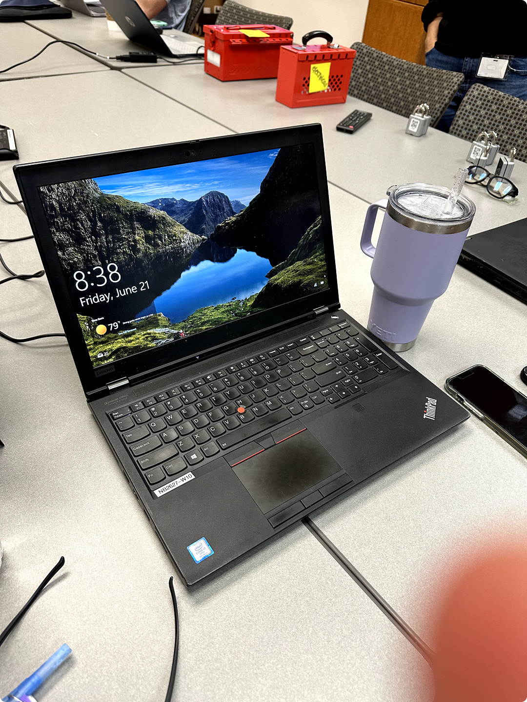 Lenovo ThinkPad laptop showing 8:38 time and June 21 date, with a purple Yeti cup on the desk.