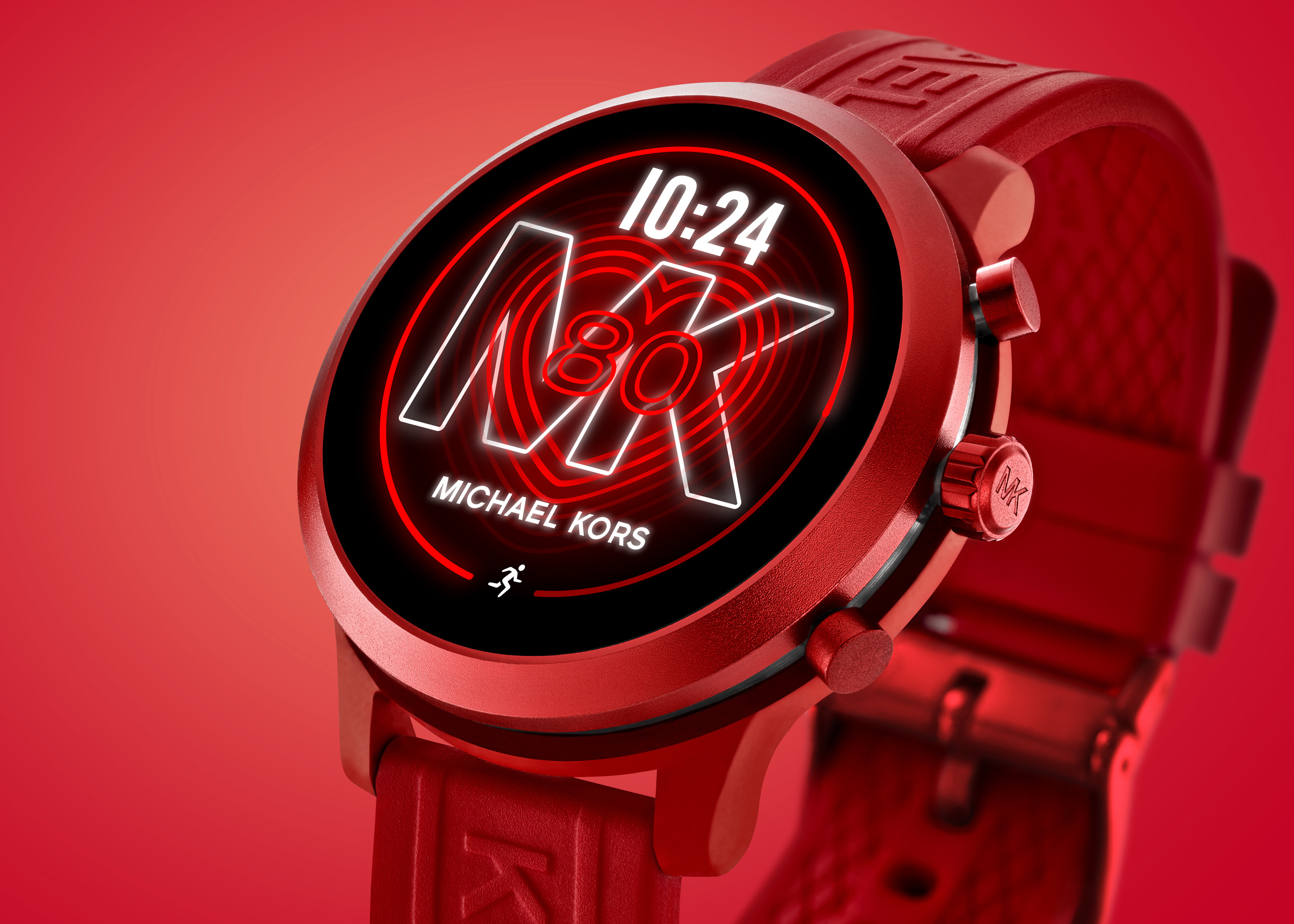 Close-up of a red Michael Kors smartwatch with digital time and logo on the screen.