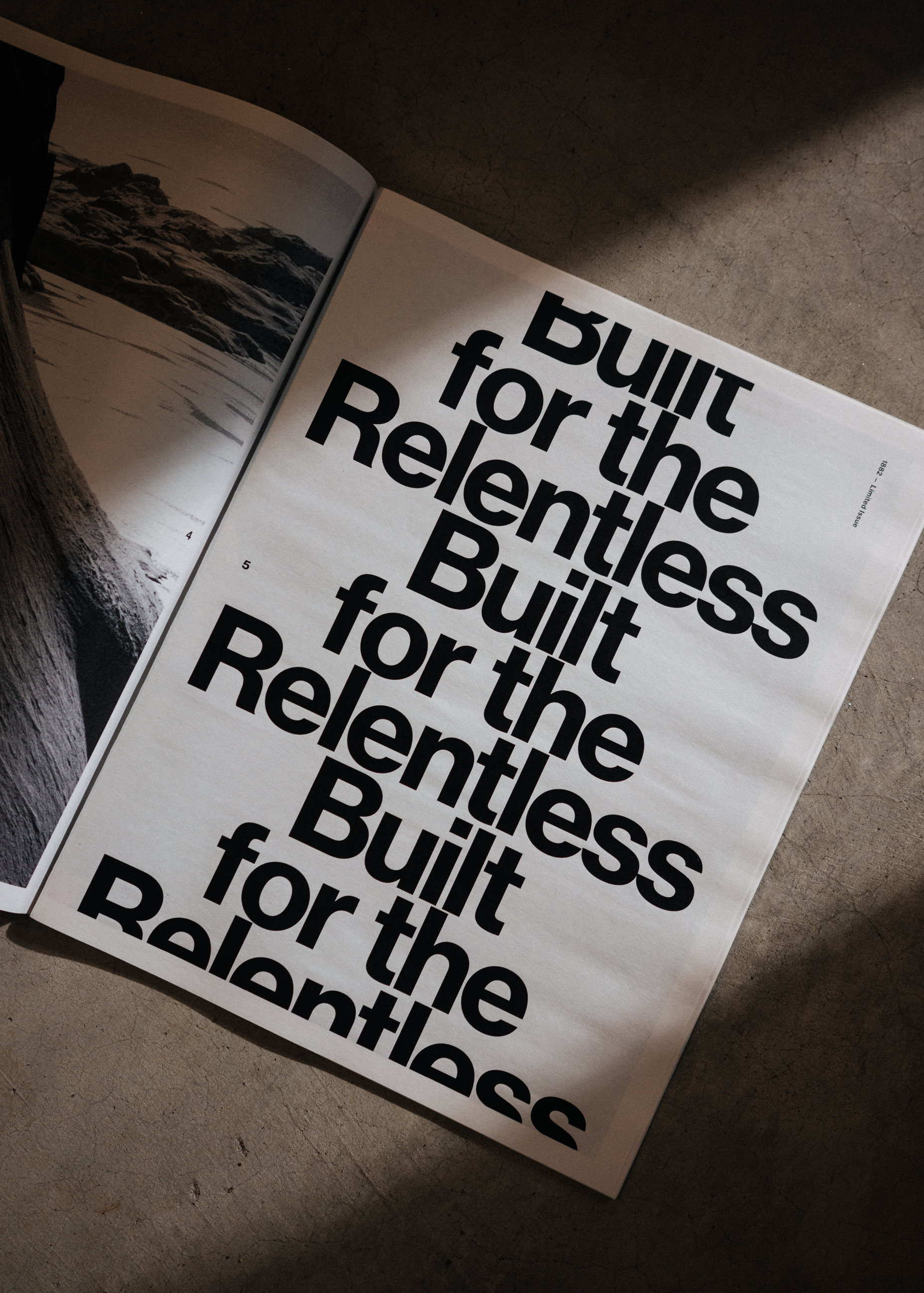 Open book on floor with repeated bold text saying 'Built for the Relentless'.