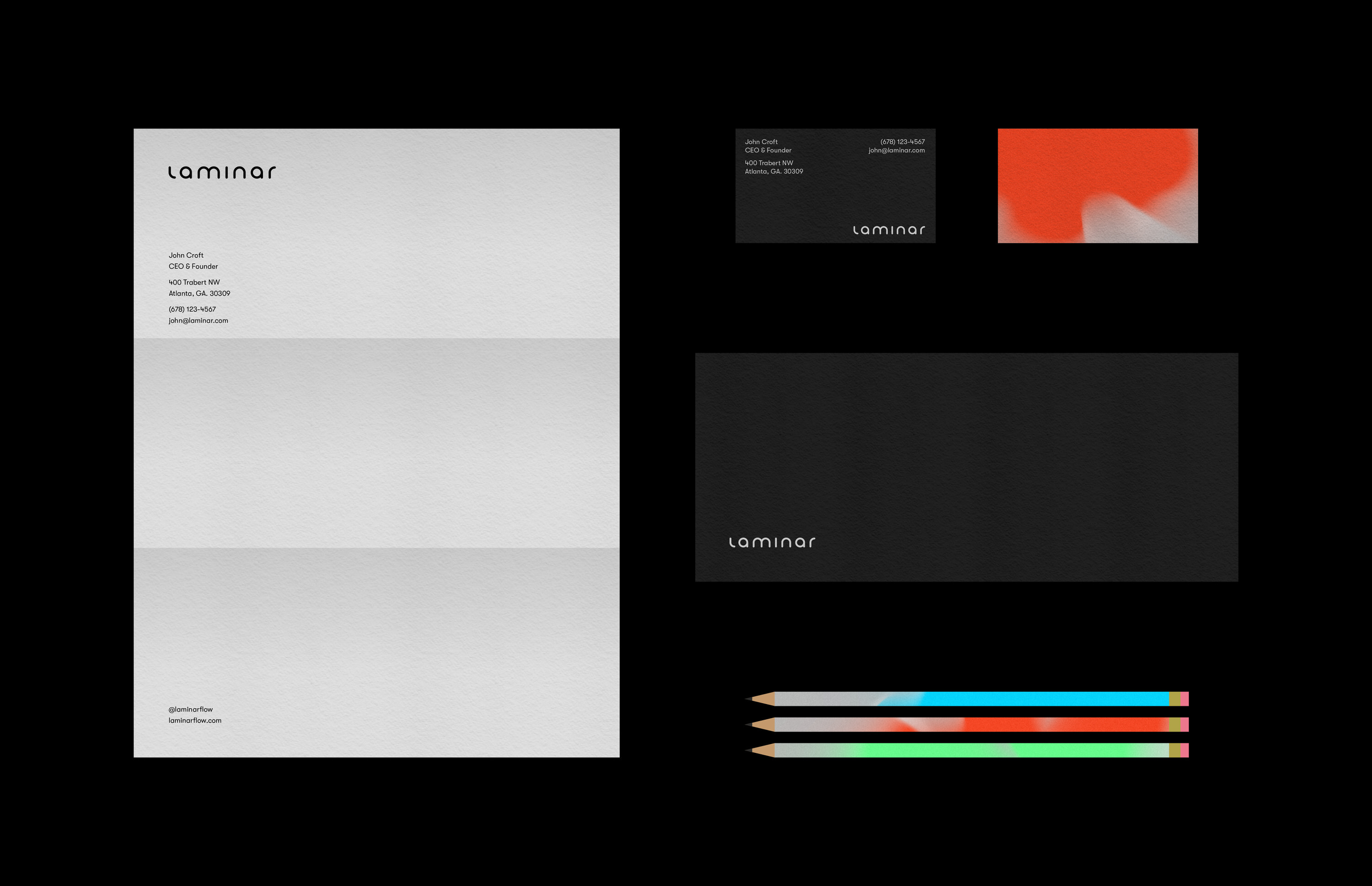 Stationery set with Laminar brand, including letterhead, black business card, envelope, and colored pencils.