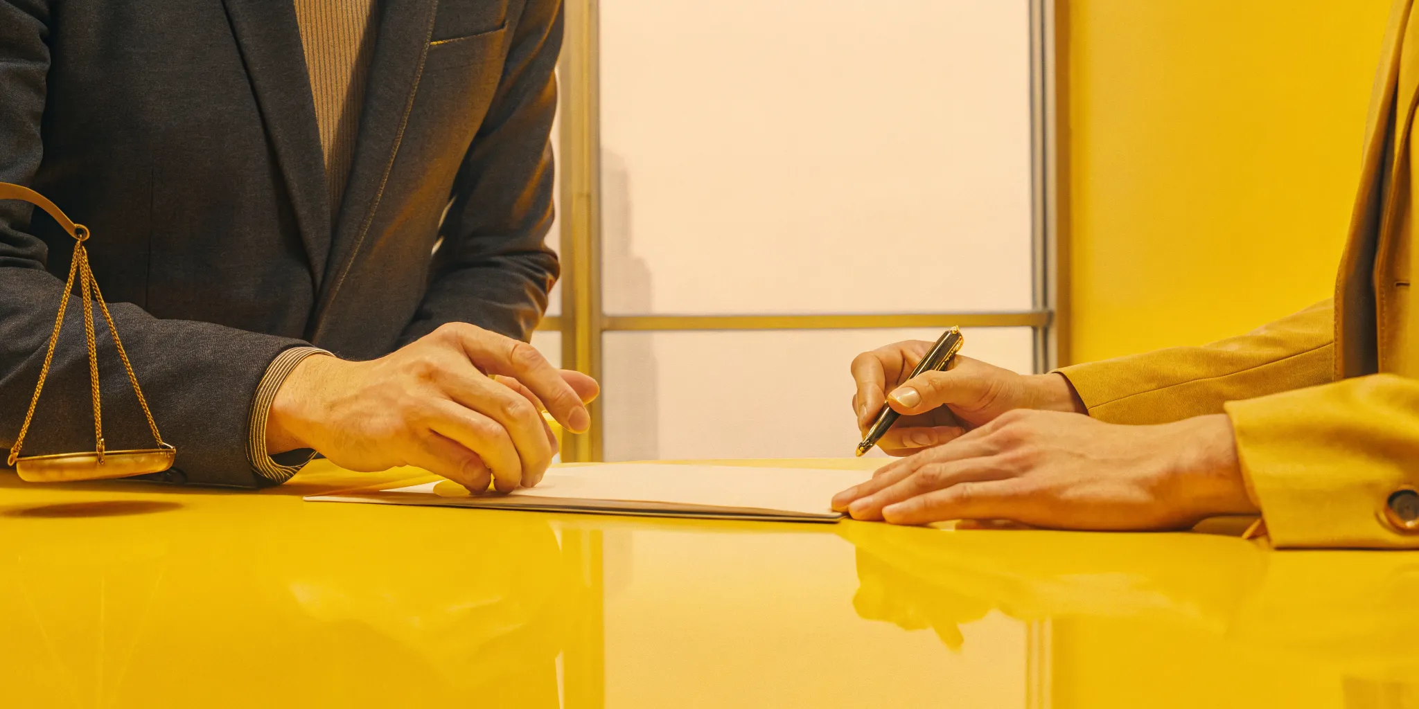 A car accident lawyer helps a client with the legal paperwork for their claim.