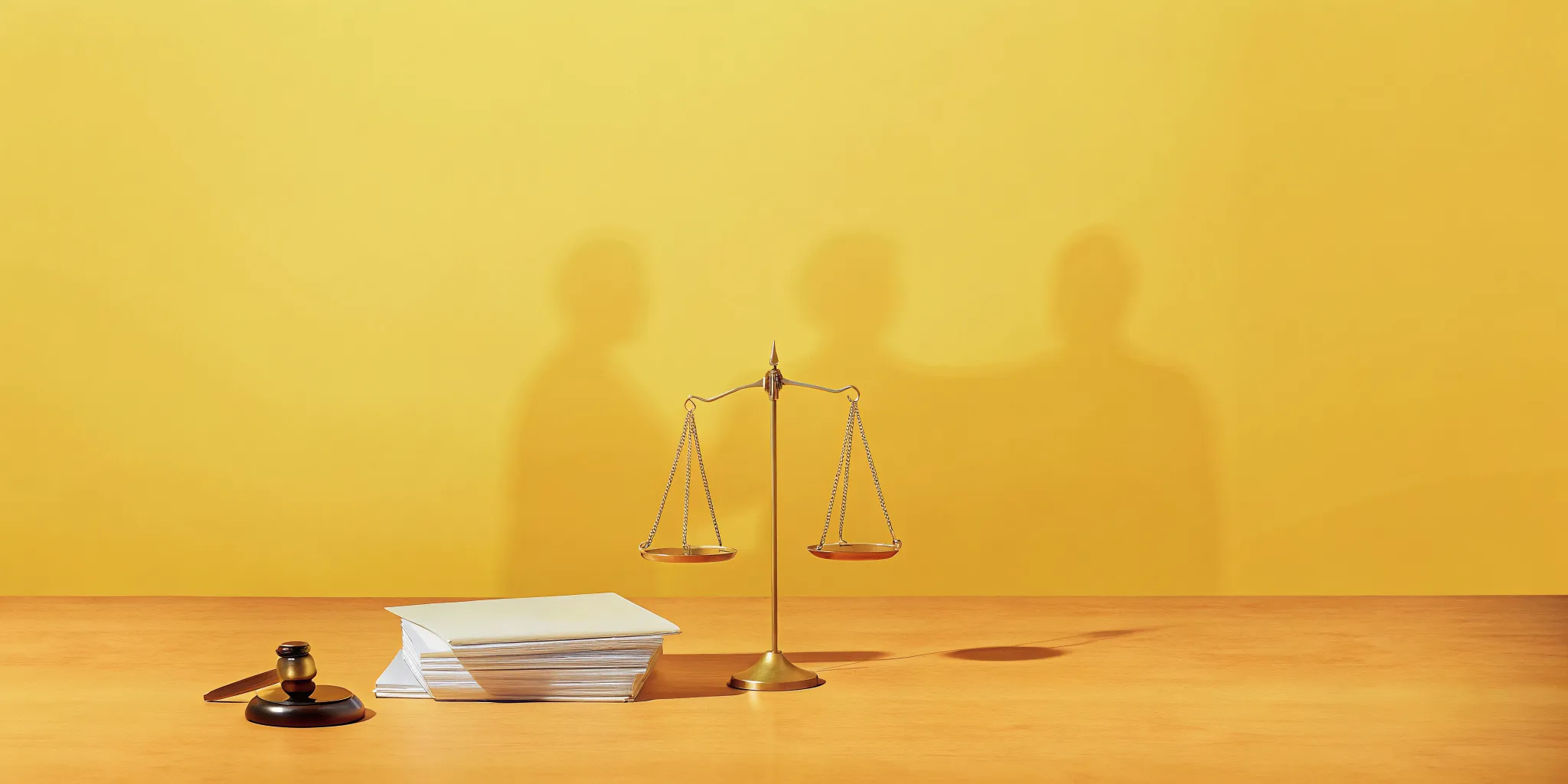 Gavel, scales of justice, and legal files on a desk for a wrongful death lawsuit.