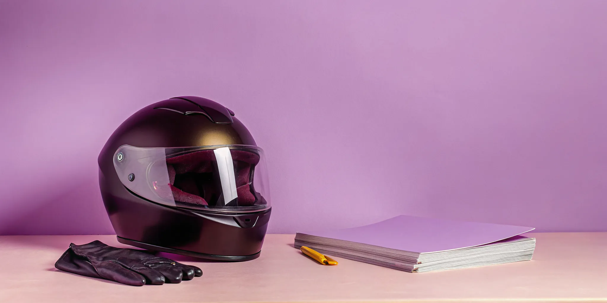 Motorcycle helmet and gloves with paperwork for a motorcycle injury compensation claim.