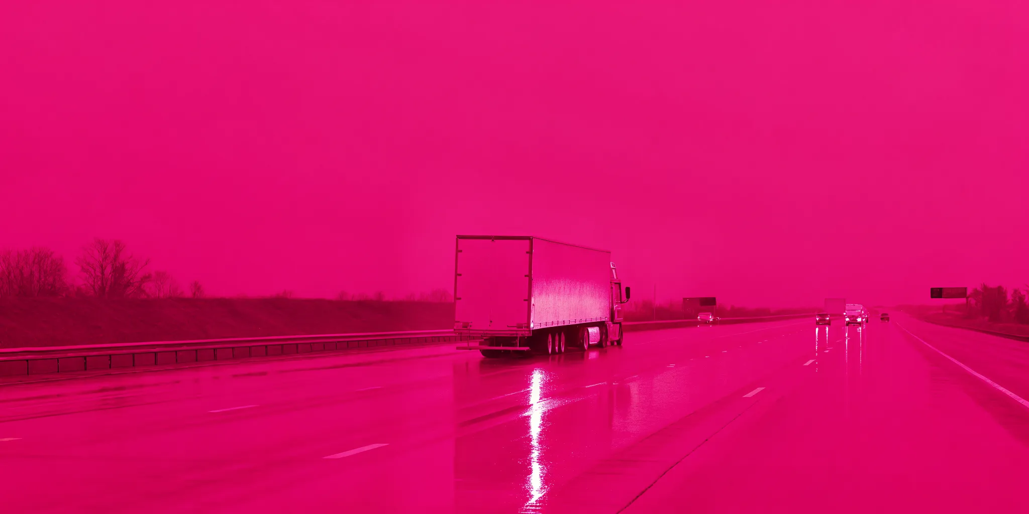 Jackknifed tractor trailer blocking a wet highway