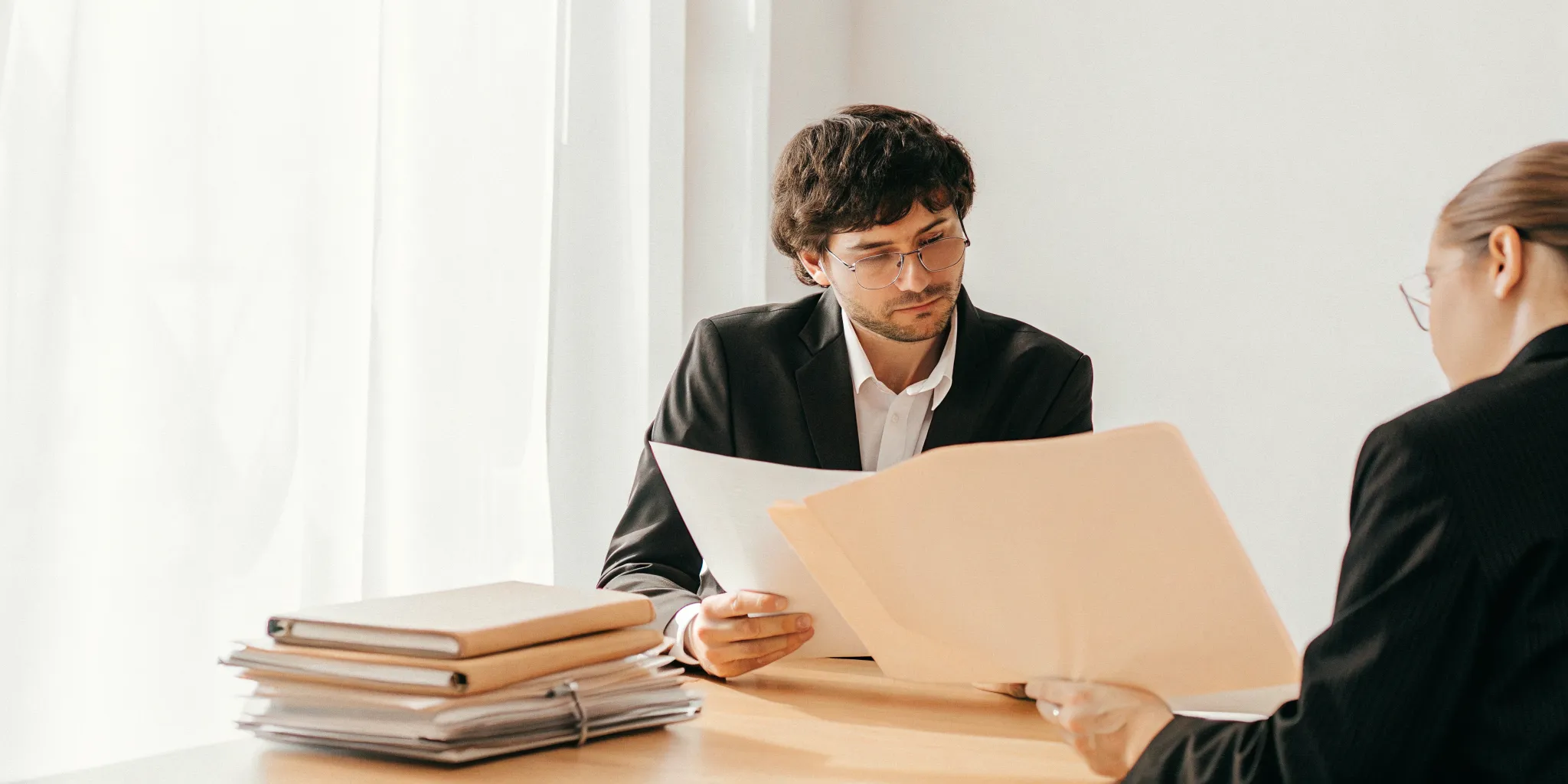 Cornwell attorney reviewing a case file with an injured client in a Savannah office