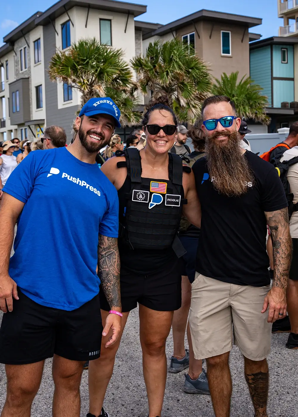 Three PushPress employees at an outdoor gathering.