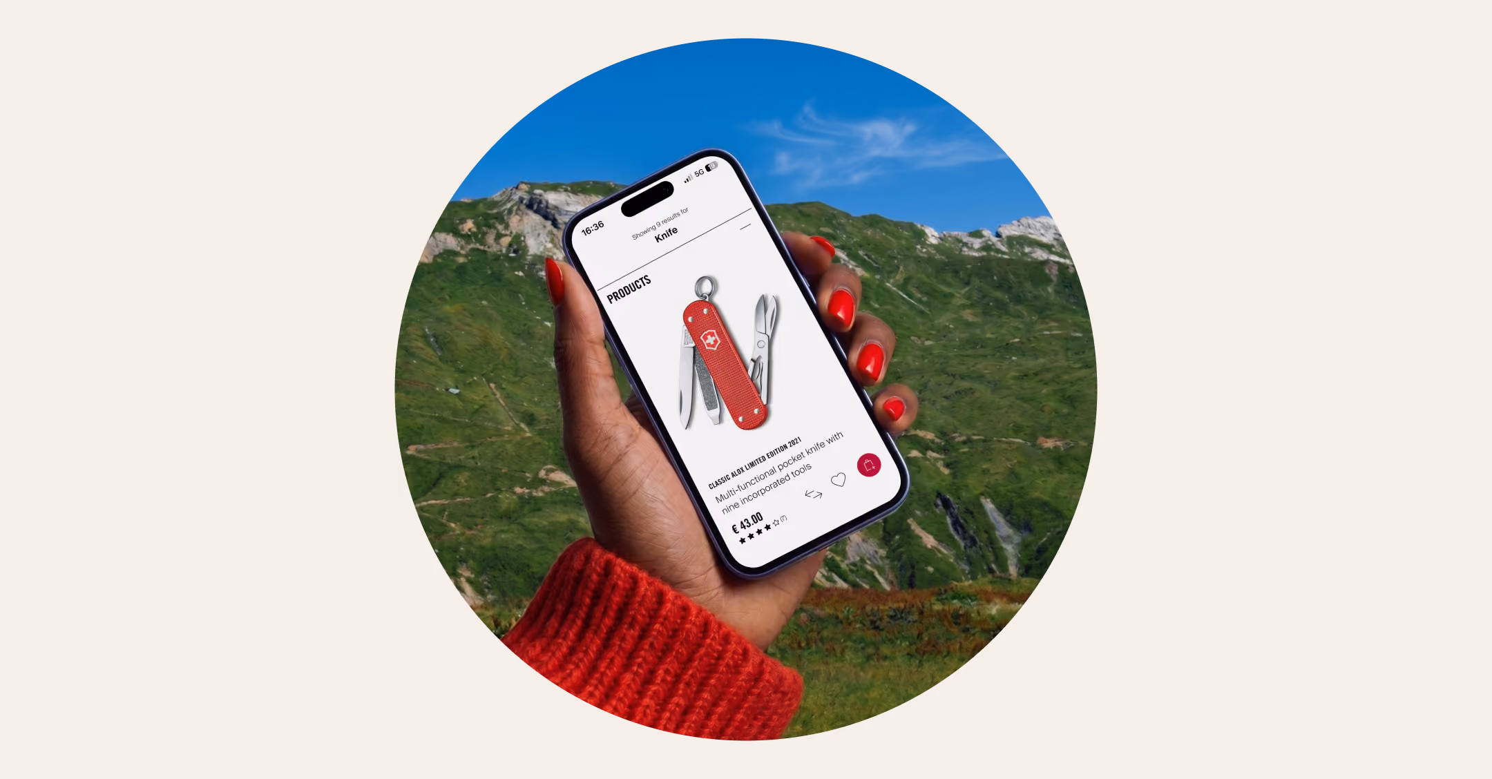 Hand holding phone showing red multifunctional Victorinox pocket knife product page with mountain background.