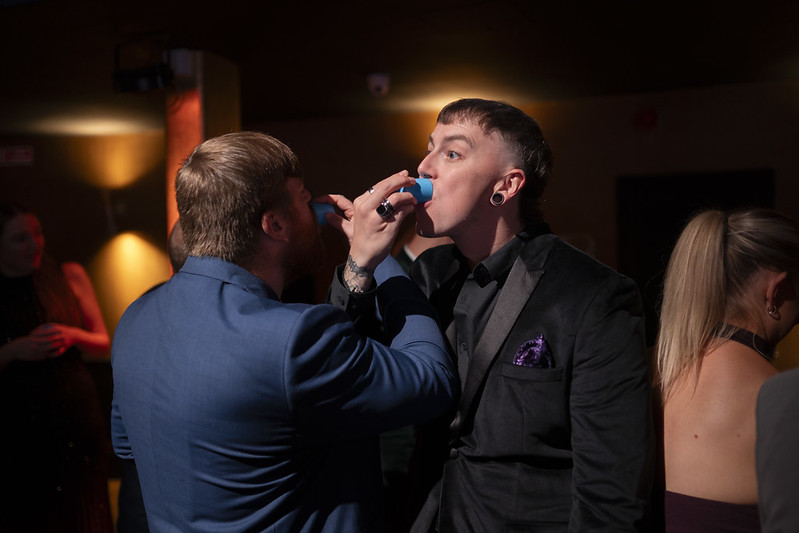 Ashley and Sam take a shot of tequila together at the Global Search Awards 2025.