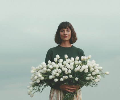 woman holding a bunch of white flowers