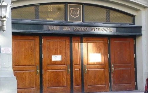 The De Soto School entrance with wooden doors