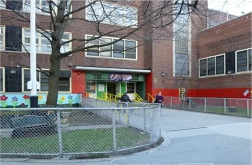 School courtyard with students and brick building facade