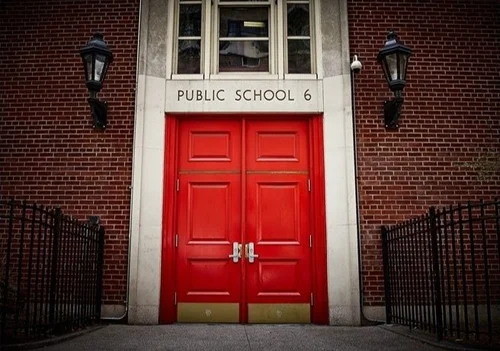 Public School 6 entrance with red double doors