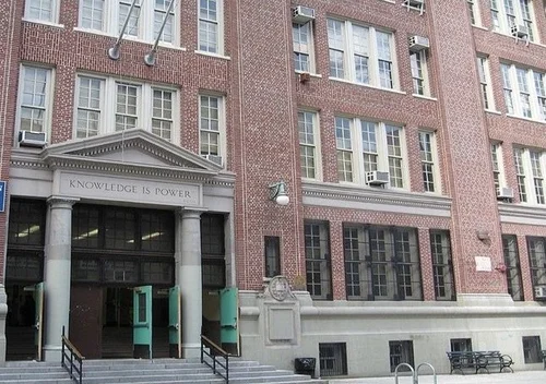 Brick school building entrance with Knowledge is Power inscription