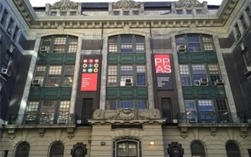 Historic P.S. 212 building facade with arched windows