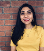 Neha Sobti, staff member smiling in yellow shirt