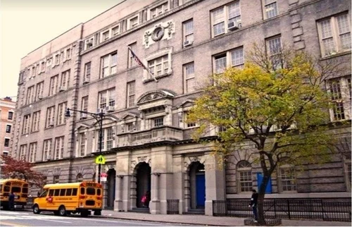 P.S. 158 Bayard Taylor school building exterior with yellow bus