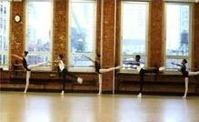 Empty dance studio with barres and large windows