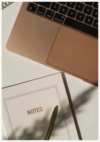 Laptop with notes and pen representing executive virtual assistant services for leaders