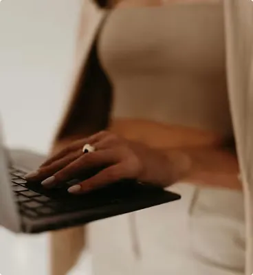 Executive Luxe service with professional woman typing, providing executive virtual assistant services combining strategy and operations