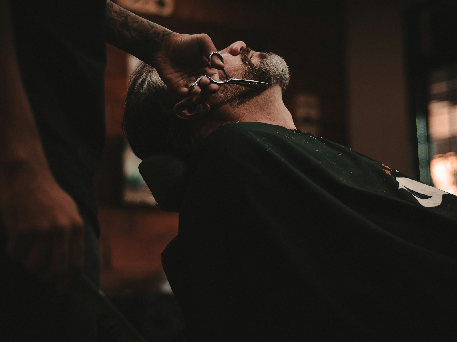 A man sitting in a barber's chair