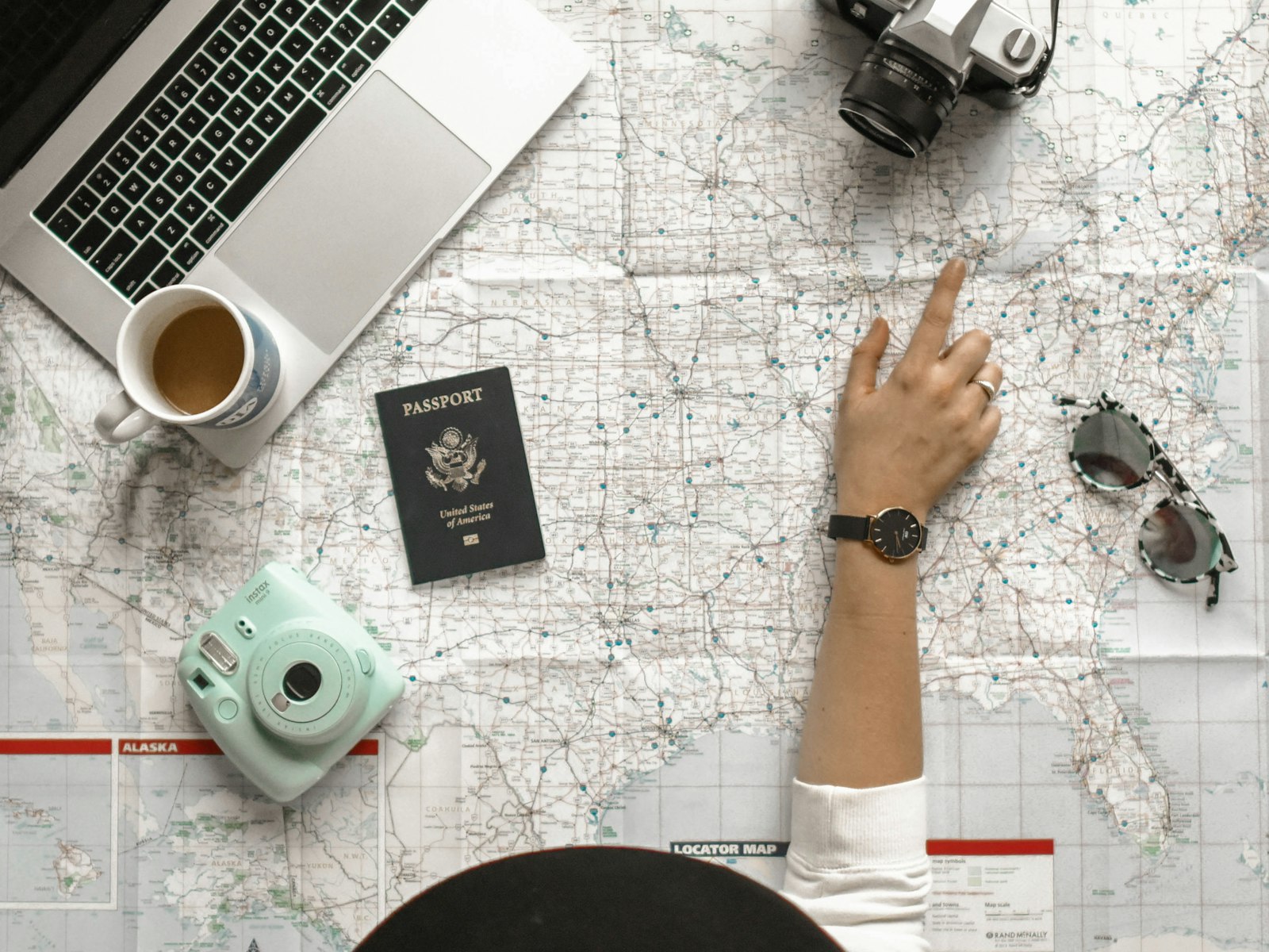 A person pointing at a map while planning a trip