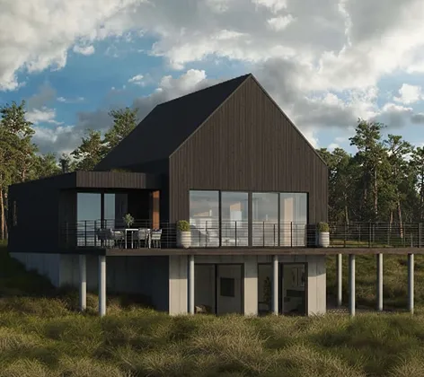 Modern black elevated house with large glass windows and a balcony surrounded by grassy landscape under a cloudy sky.