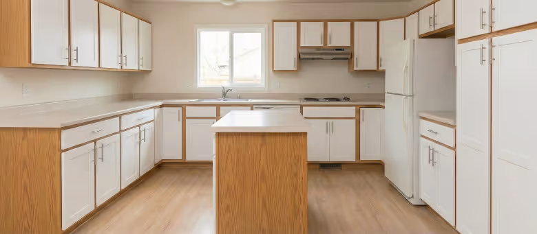 Completed kitchen cabinet refacing project in Calgary, showcasing a bright and modern kitchen interior with fresh white cabinet doors and new contemporary hardware. | Quickfix Handyman Inc.