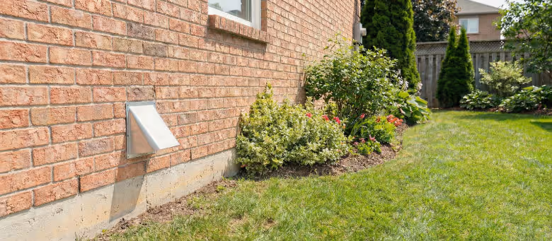 Clean and clear exterior dryer vent after professional maintenance in Calgary, showing a properly functioning vent cover on a brick wall to ensure home safety and efficiency | Quickfix Handyman Inc.