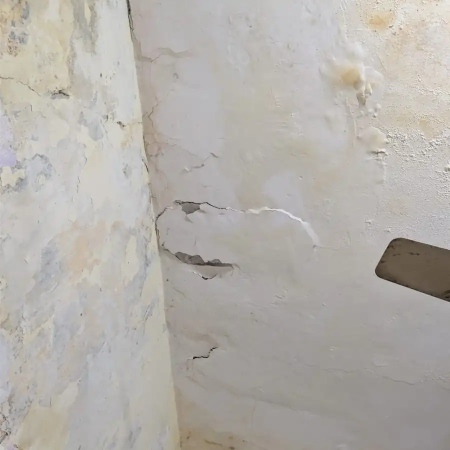 Severe ceiling concrete spalling exposing rusted structural rebar