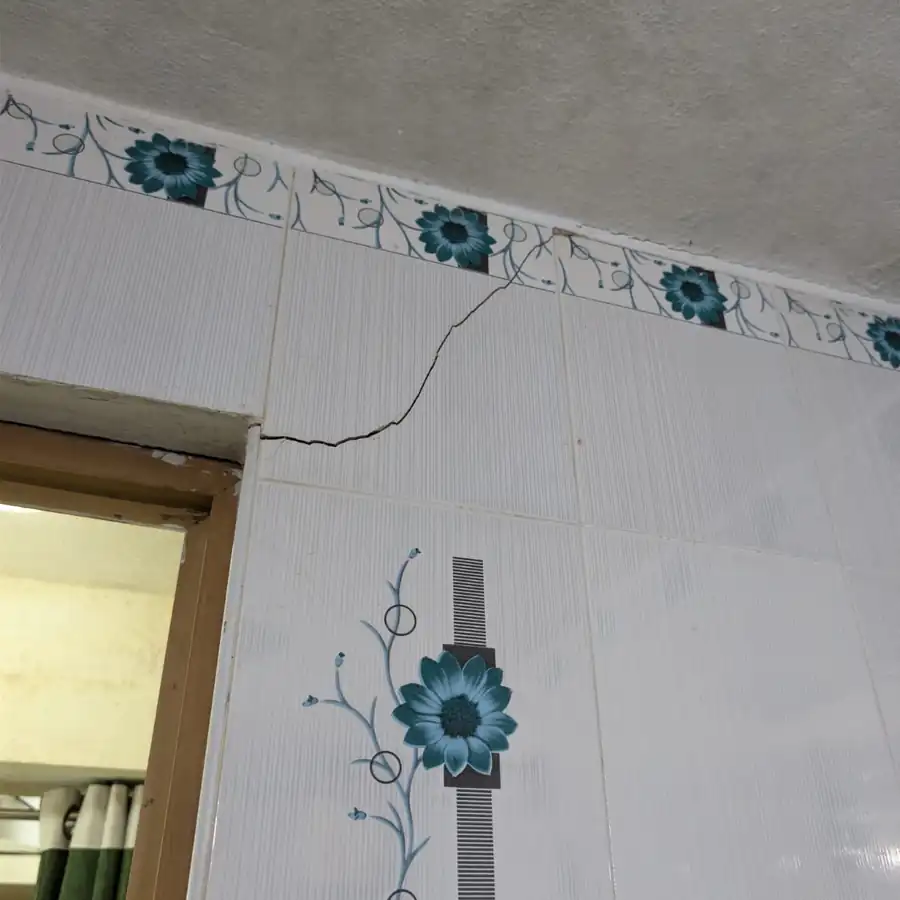 Diagonal shear crack in a brick wall indicating foundation settlement