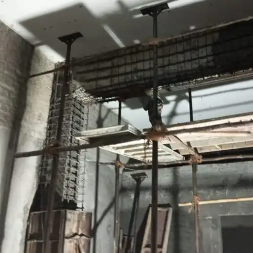 Structural strengthening work showing reinforced concrete column and beam with steel reinforcement bars