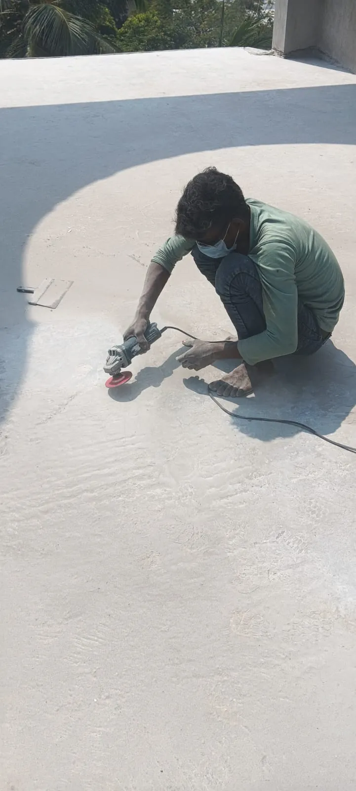 Mechanical angle grinder preparing structural concrete slab for waterproofing in Chennai