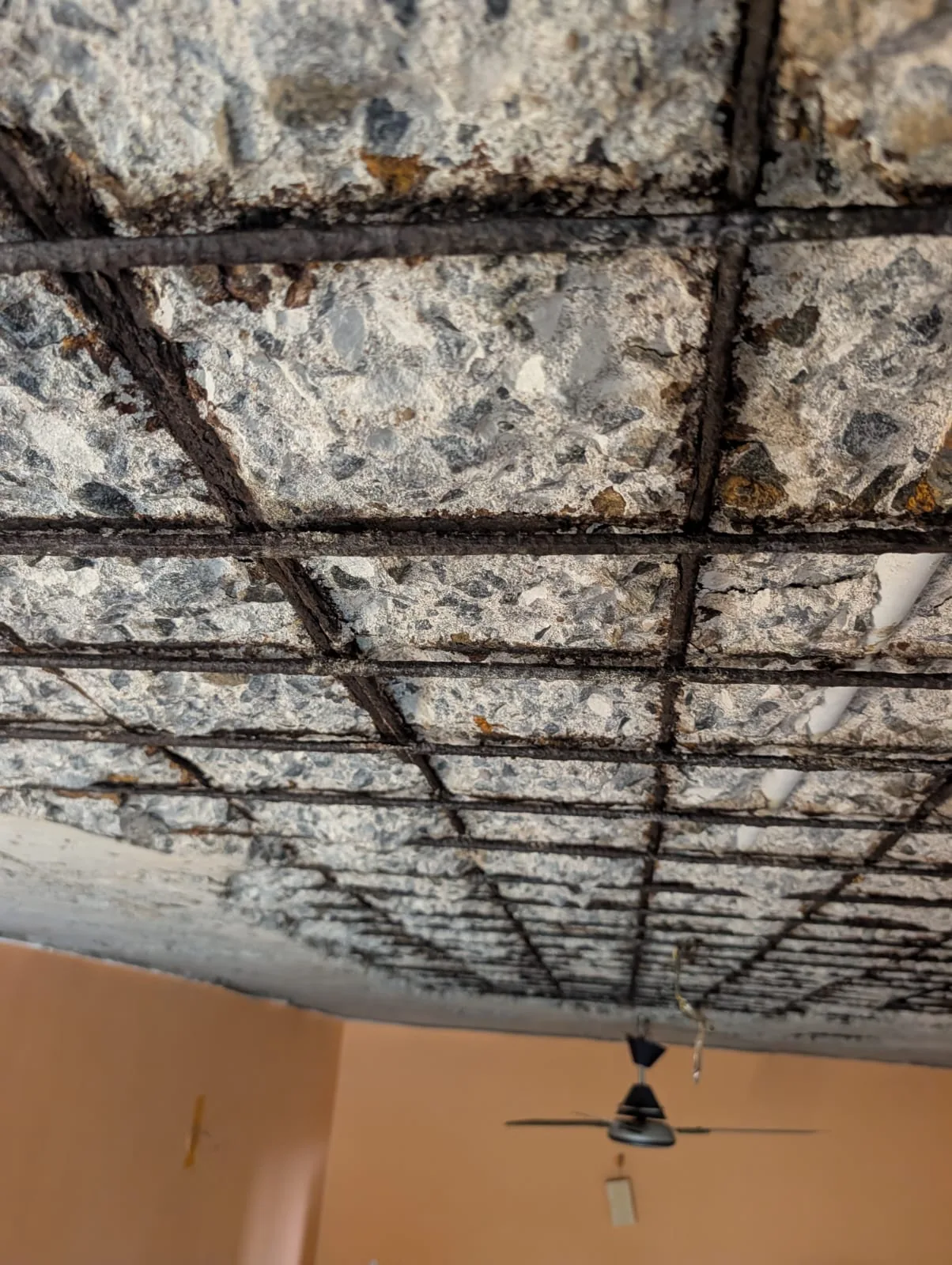 Ceiling cracks and hollow plaster from terrace leakage — apartment building structural damage Chennai