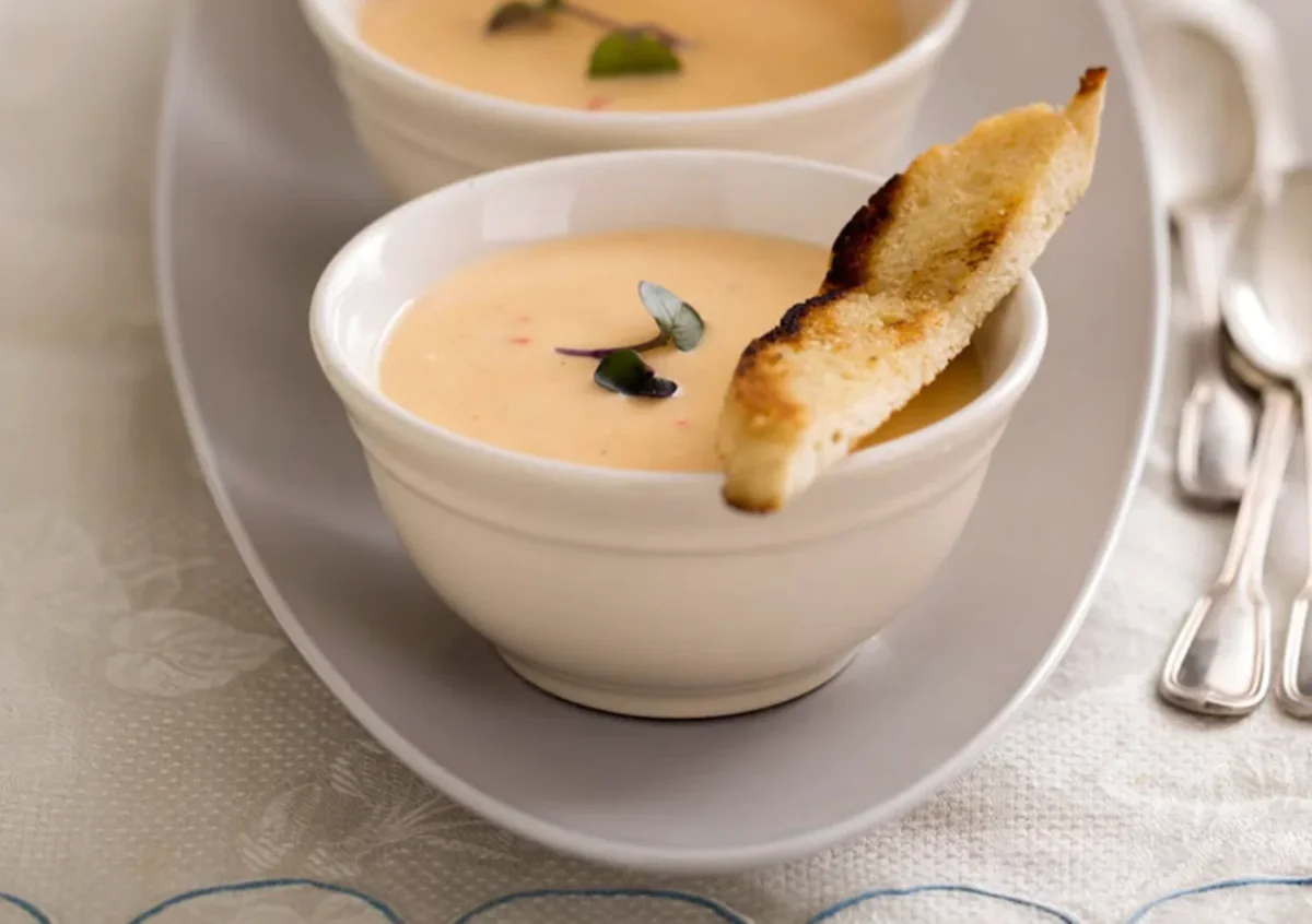 A bowl of soup with toasted bread