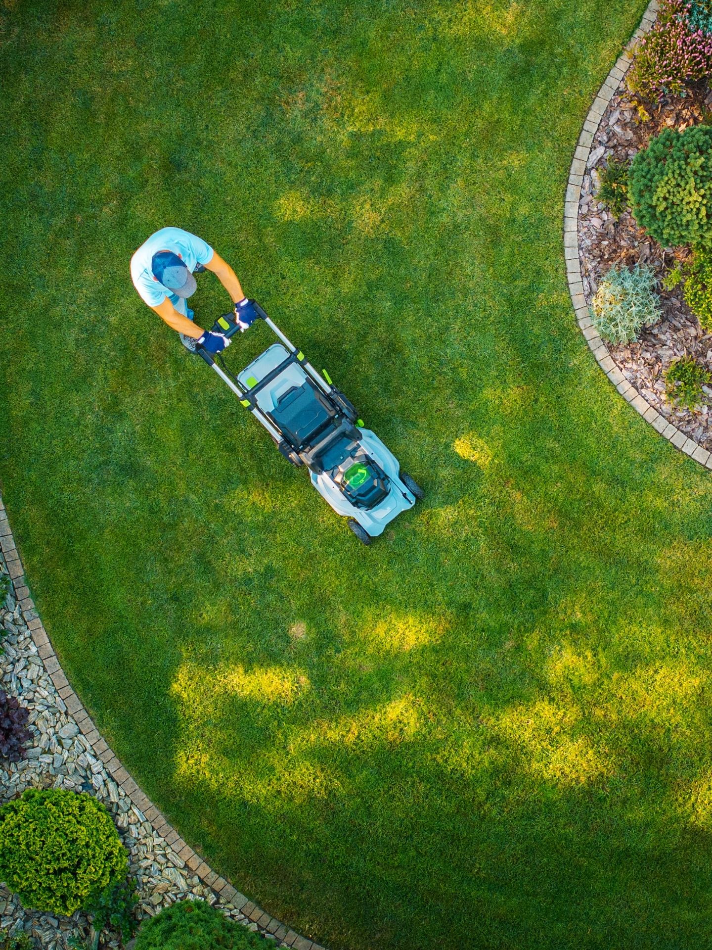 Lawn care professional mowing a residential lawn