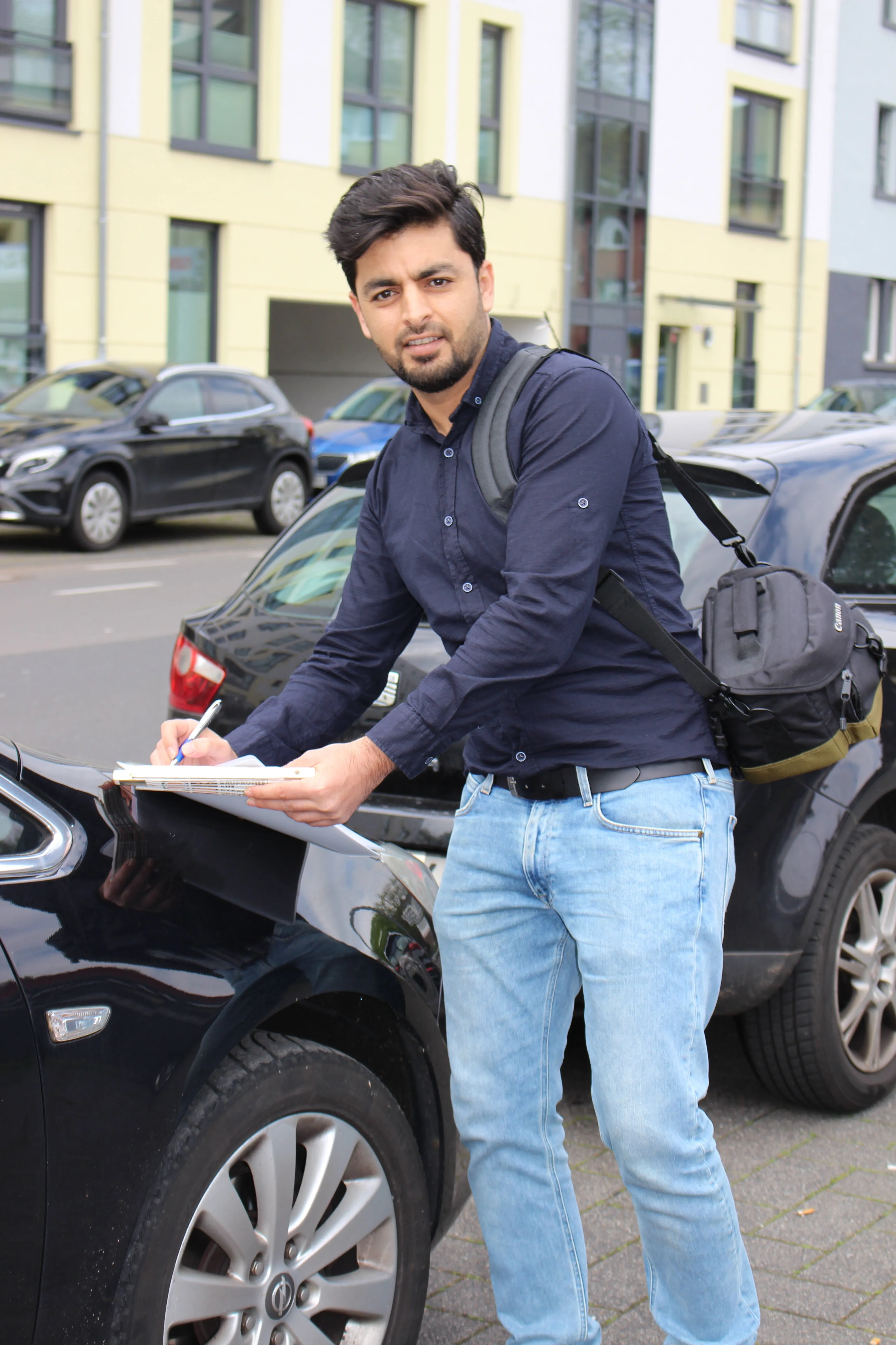 A man inspecting car